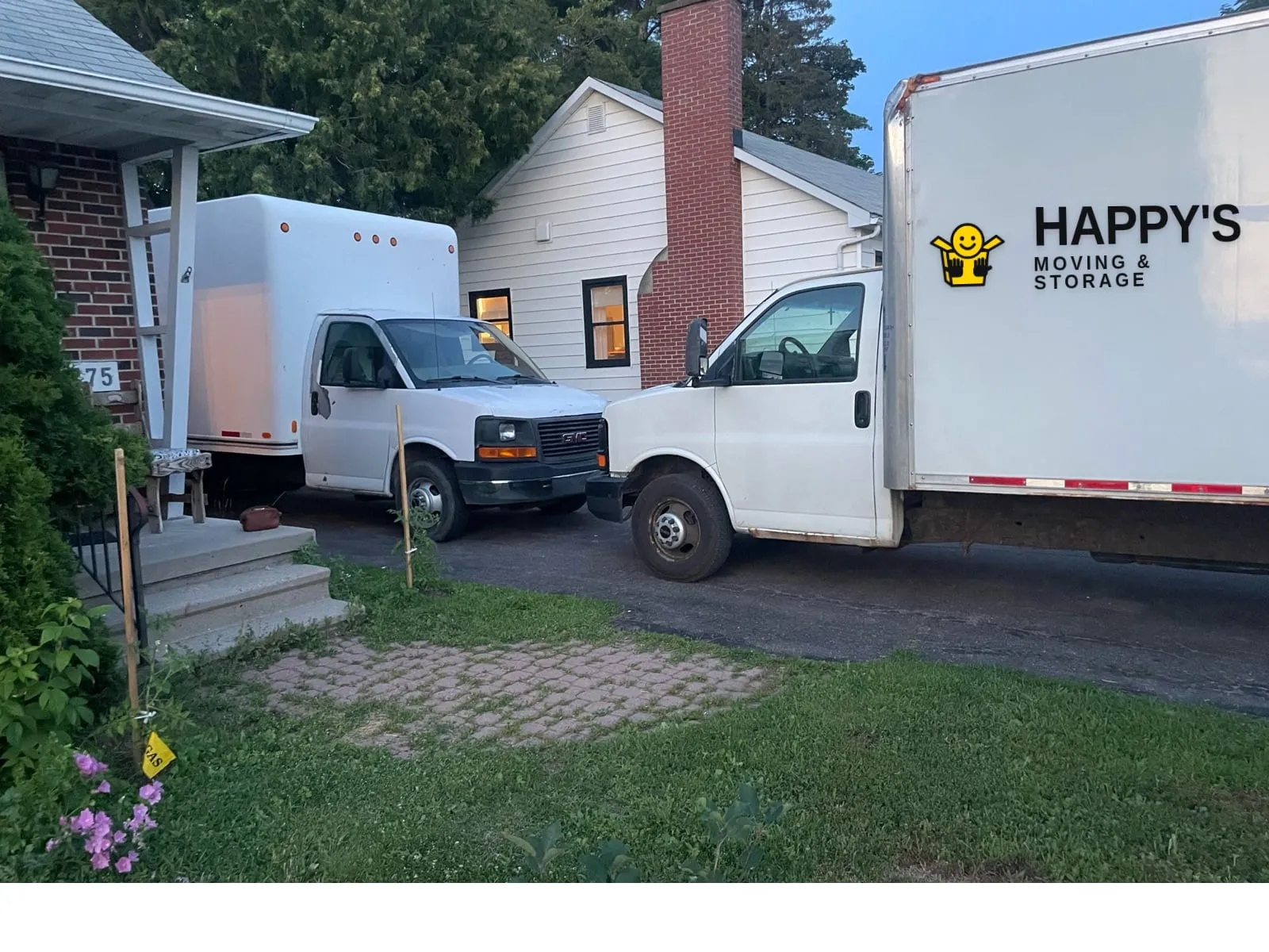 Happy's Moving & Storage box truck with the logo on the side, in an Ottawa Valley driveway on moving day